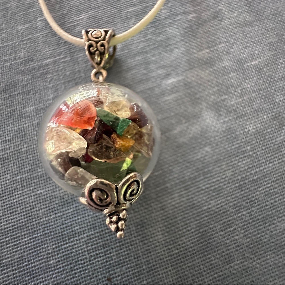 Talisman necklace, glass ball pendant full of healing crystals.
